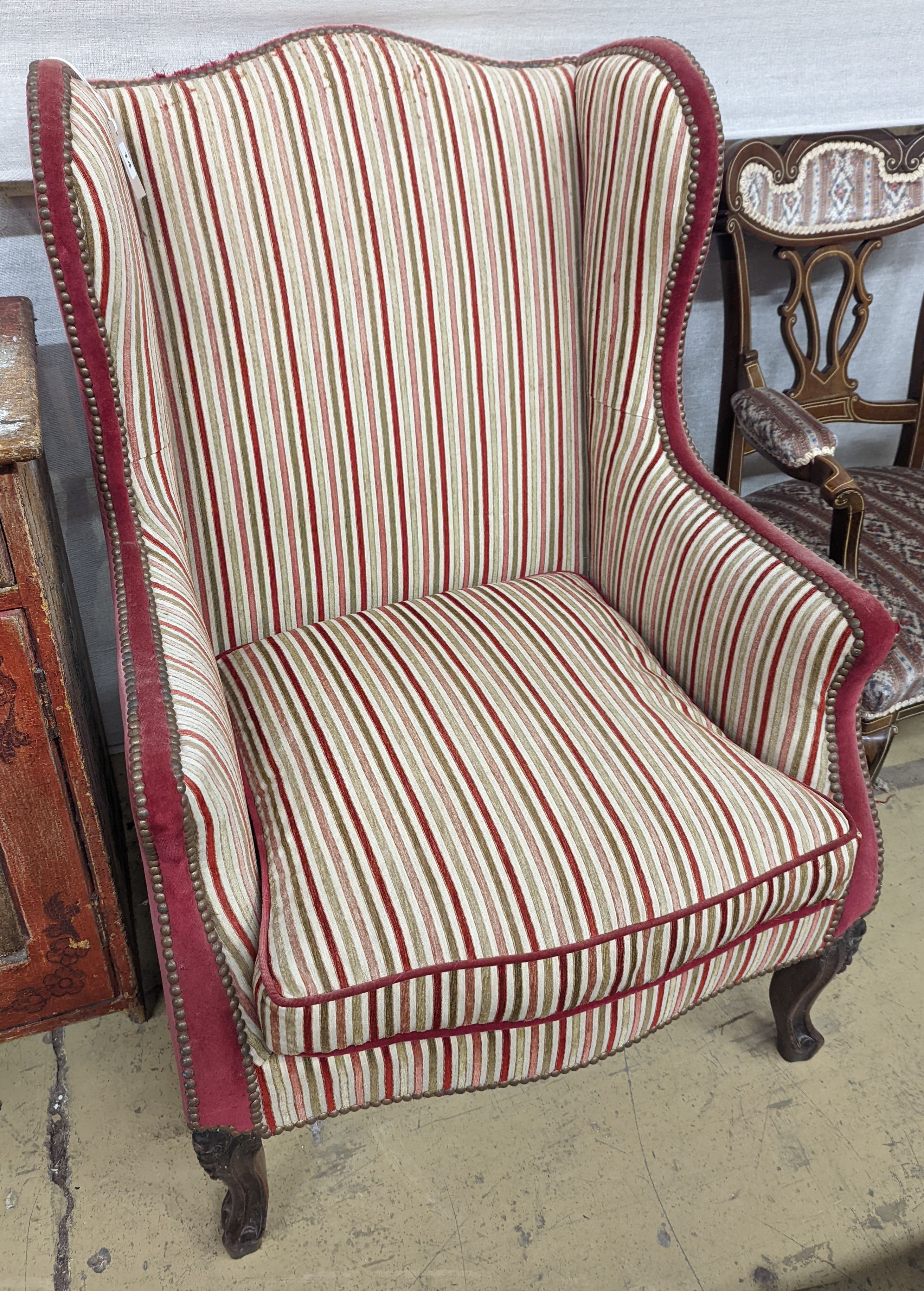 A 19th century Louis XVI style upholstered wing armchair, width 71cm, depth 74cm, height 104cm